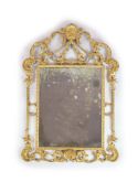 A George III style carved giltwood wall mirror,with rectangular plate and pierced foliate scroll