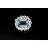 A gold and silver, aquamarine and diamond set oval cluster brooch,the emerald cut aquamarine