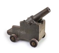 A cast iron starting cannon, probably 18th/19th century,on a wooden carriage with cast iron wheelsH
