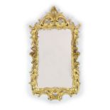 A George III carved giltwood wall mirror,of rectangular cartouche form with elaborate foliate