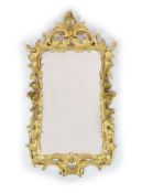 A George III carved giltwood wall mirror,of rectangular cartouche form with elaborate foliate