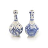 A pair of small Chinese blue and white garlic-neck vases, Kangxi periodeach painted two arched