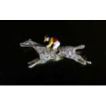 An early 20th century gold, diamond chip and enamel set 'horse and jockey' brooch,32mm, gross 4.5