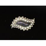 A George IV gold, graduated split pearl and black enamel leaf shaped mourning brooch,with plaited