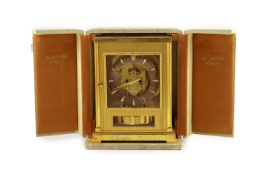 A Jaeger le Coultre Atmos clockIn lacquered gold case with silvered dial and Arabic numerals,