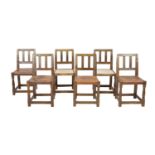 A set of six Robert Thompson 'Mouseman' oak dining chairs,with plain twin bar backs and leather