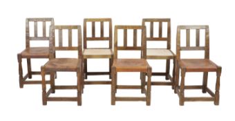 A set of six Robert Thompson 'Mouseman' oak dining chairs,with plain twin bar backs and leather