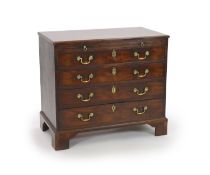 A George III mahogany chest of four graduated long drawers with brushing slideand brass loop