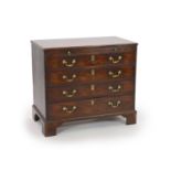 A George III mahogany chest of four graduated long drawers with brushing slideand brass loop