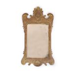 A George II giltwood and gesso wall mirror, of shaped form with contemporary rectangular