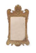 A George II giltwood and gesso wall mirror, of shaped form with contemporary rectangular