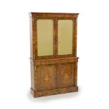 A Victorian ormolu mounted marquetry inlaid walnut bookcase,with moulded cornice and two glazed