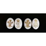 A pair of gold and white enamel oval cufflinks, each gilded with Prince of Wales Feathers and