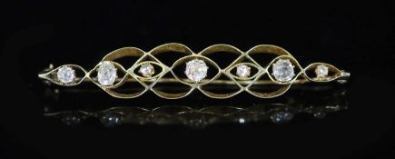 A gold and seven stone graduated rose and old mine cut diamond set bar brooch,67mm, gross 6.8