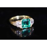 A good early 20th century gold, single stone trap cut emerald and two stone old cut diamond set