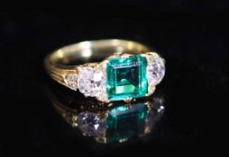 A good early 20th century gold, single stone trap cut emerald and two stone old cut diamond set