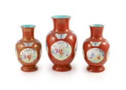 A set of three Chinese coral ground ‘boys’ vases, Jiaqing period (1796-1820),each painted in