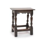 A Charles I oak joint stool,With shaped freeze and turned inverted baluster legsH 54cm. W 48cm. D