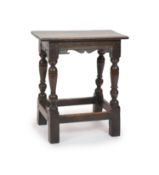 A Charles I oak joint stool,With shaped freeze and turned inverted baluster legsH 54cm. W 48cm. D