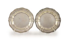 A pair of late George IV silver shaped circular dinner plates by Paul Storr,decorated with