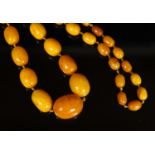 A single strand graduated oval amber bead necklace, 98cm, gross weight 117 grams.