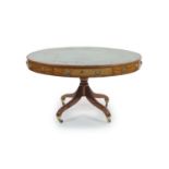 A Regency mahogany oval topped library table,with tooled green leather inset top and four freize