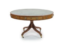 A Regency mahogany oval topped library table,with tooled green leather inset top and four freize