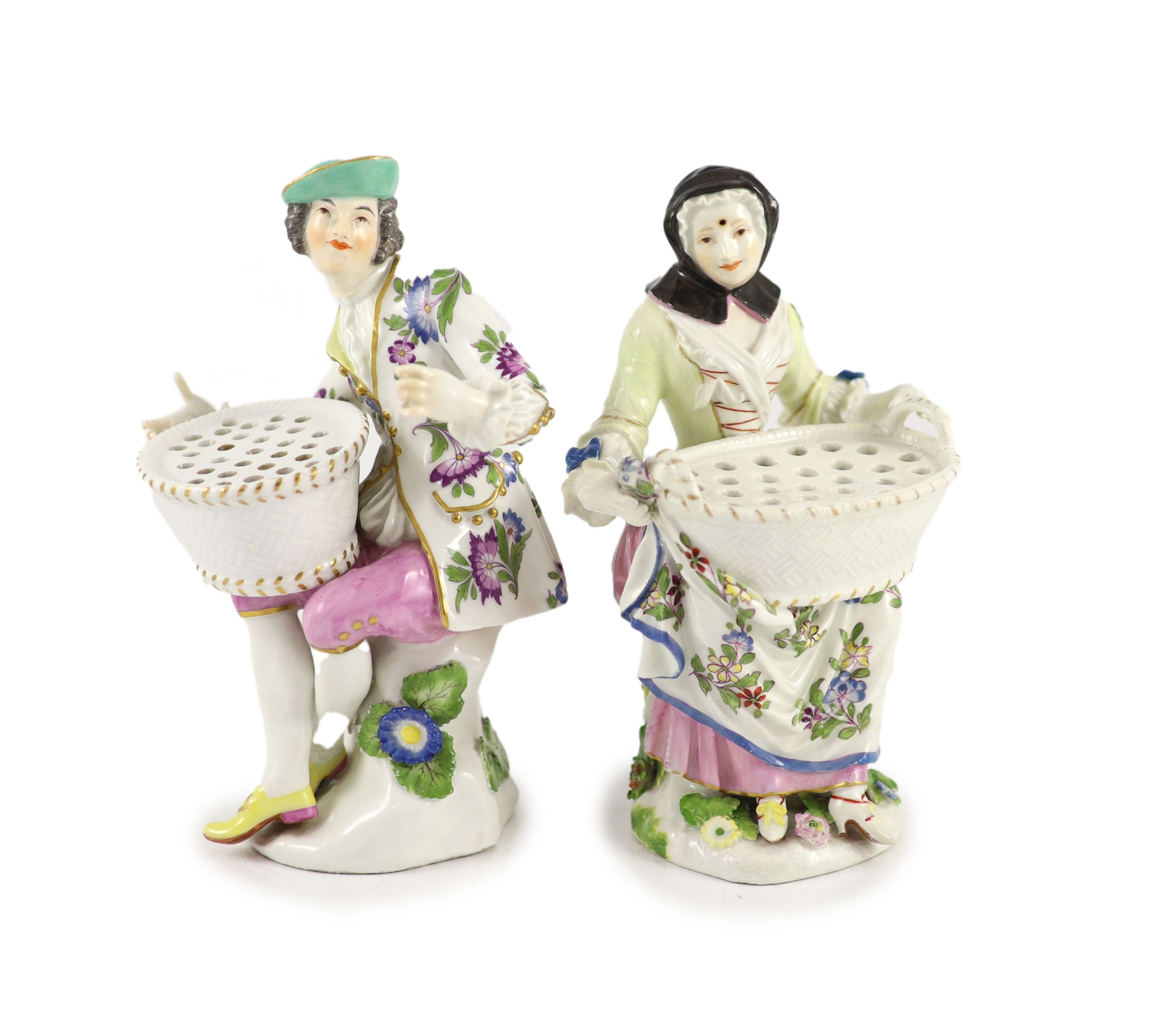 A pair of Meissen figural flower holders c.1755,modelled as a seated lady and gentlemen holding a