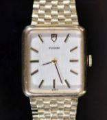 A lady's 1980's 9ct gold Tudor manual wind rectangular dial wrist watch, on an integral 9ct gold