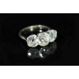 A platinum? and three stone diamond ring,set with three old cushion cut stones, with a total