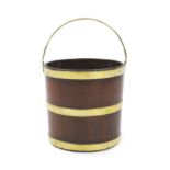 A George III mahogany peat bucket,of brass bound staved construction,W.31cm H.29cm