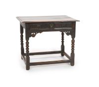 A Charles II oak side tablewith moulded rectangular top and panelled freize drawer, on Bobbin