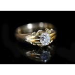 An early 20th century 18ct gold and claw set solitaire diamond ring,the oval cut stone weighing