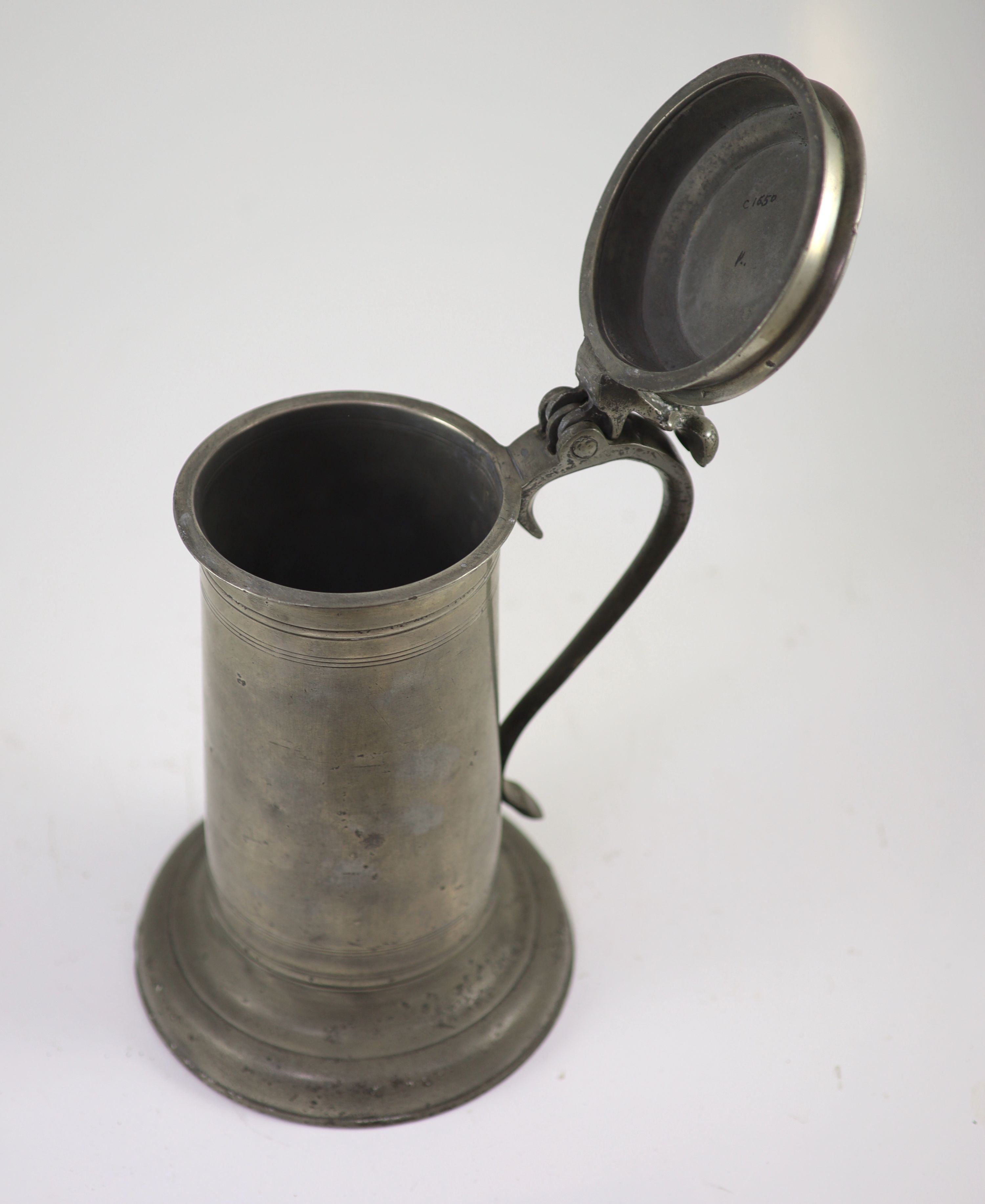 A mid-17th century pewter flagon of large proportionsWith wrythen thumbpiece and broad footH 31cm. - Image 2 of 3