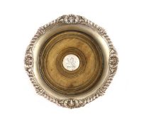 A George III silver wine coaster by Paul Storr,with gadrooned and foliate border and turned wooden