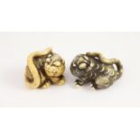 Two Japanese ivory netsuke of a tiger, Edo period, first half 19th century,each with horn inlaid