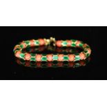 A good 1950's Cartier gold, coral bead and green enamel set articulated bracelet,with alternating