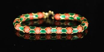 A good 1950's Cartier gold, coral bead and green enamel set articulated bracelet,with alternating