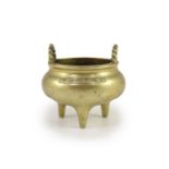 A Chinese bronze tripod censer, 18th/19th century,with a pair of rope twist handles to the rim