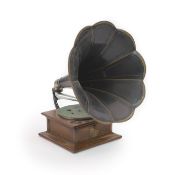 An Edwardian oak cased Columbia gramophonestamped PAT Aug 13, 1901. with a group of 78 rpm records