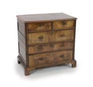 An early 18th century oak and walnut chest,with moulded top, two short and three long drawers, on