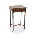 A Regency inlaid rosewood and ebony writing table,with satinwood banded rectangular twin flap top