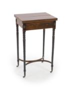 A Regency inlaid rosewood and ebony writing table,with satinwood banded rectangular twin flap top