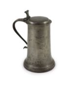 An early 17th century pewter flagon of large proportionswith scroll thumbpiece and handleH 34cm.