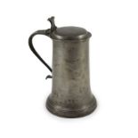 An early 17th century pewter flagon of large proportionswith scroll thumbpiece and handleH 34cm.
