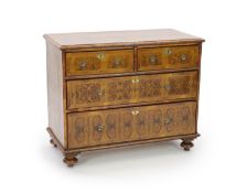 A William III and later oyster olive wood veneered chest,of two short and two long drawers, on