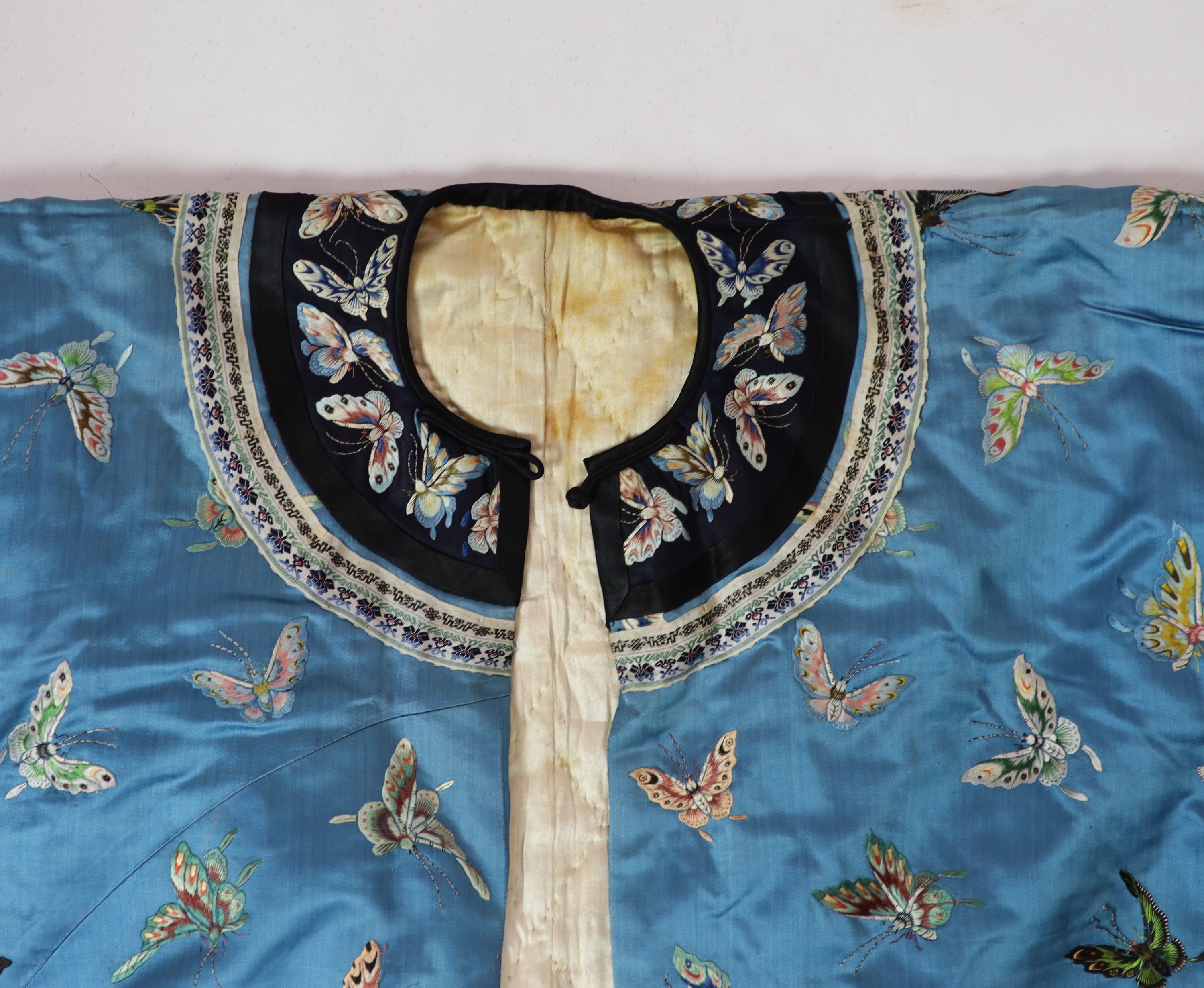 A Chinese blue silk ‘butterfly’ Winter robe, late 19th century,embroidered with butterflies on a - Image 5 of 7