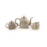 A late 19th/early 20th century Chinese Export silver three piece tea set (a.f.),comprising a