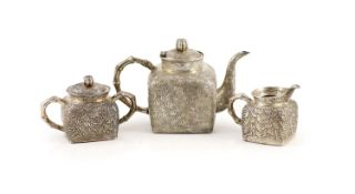 A late 19th/early 20th century Chinese Export silver three piece tea set (a.f.),comprising a