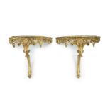 A pair of Louis XV style carved giltwood console tablesWith serpentine white marble tops, scroll
